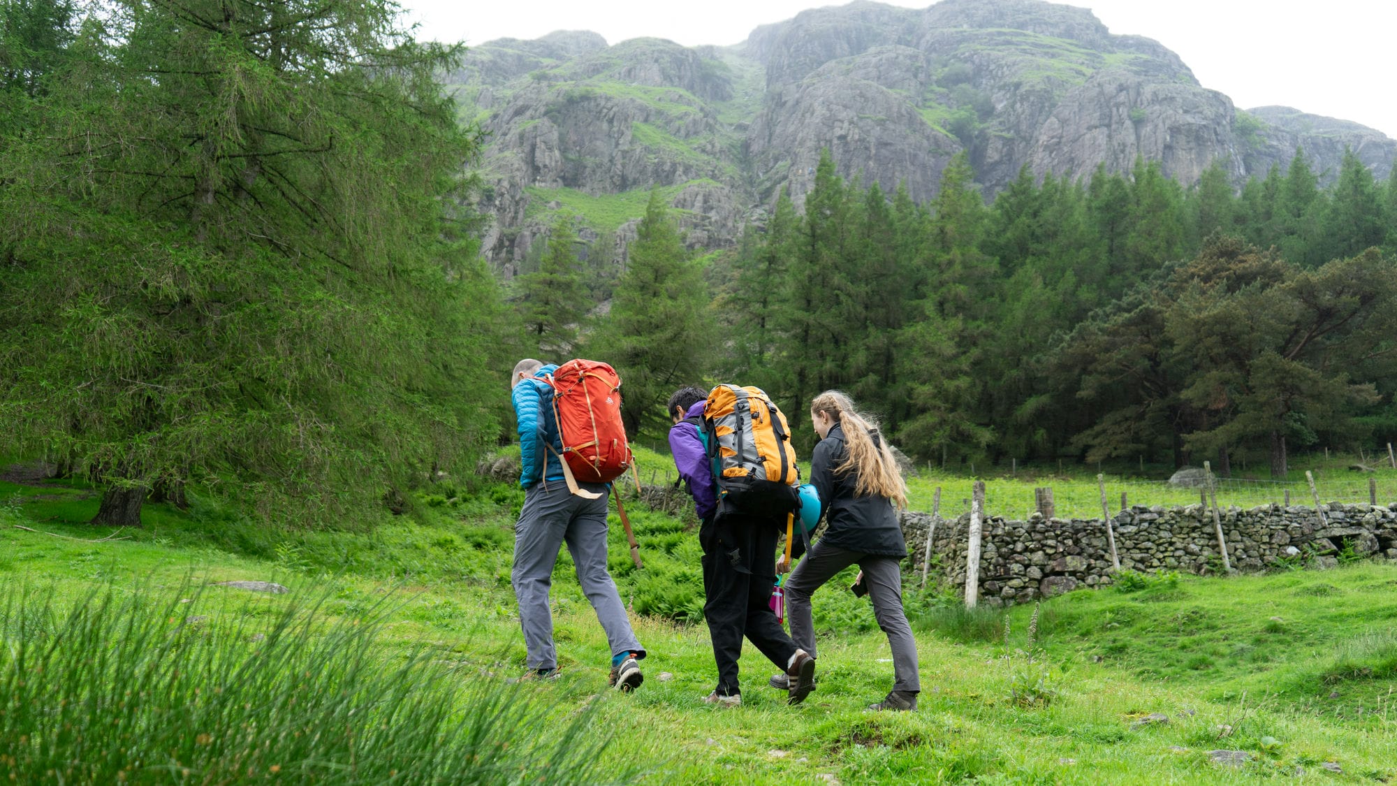 people walking to the crag for a climbing adventure day