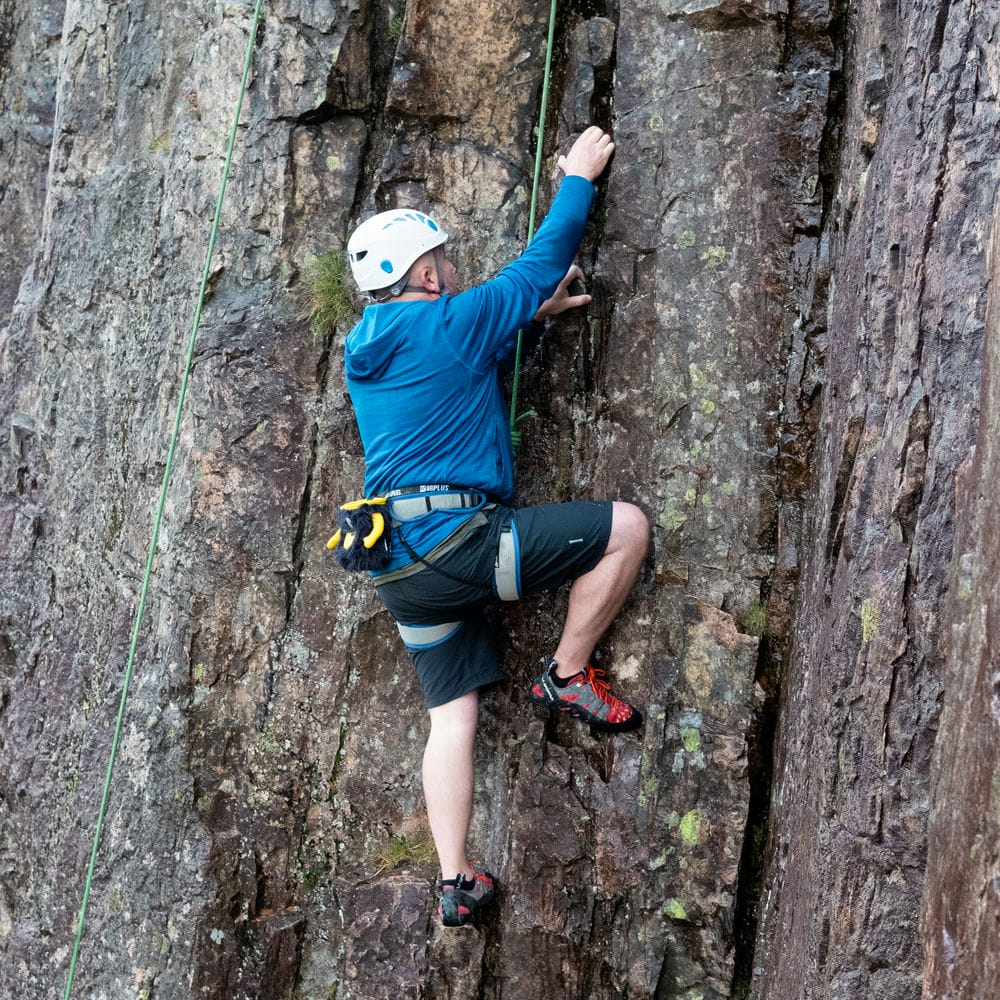 someone top roping practicing movement skills on rock