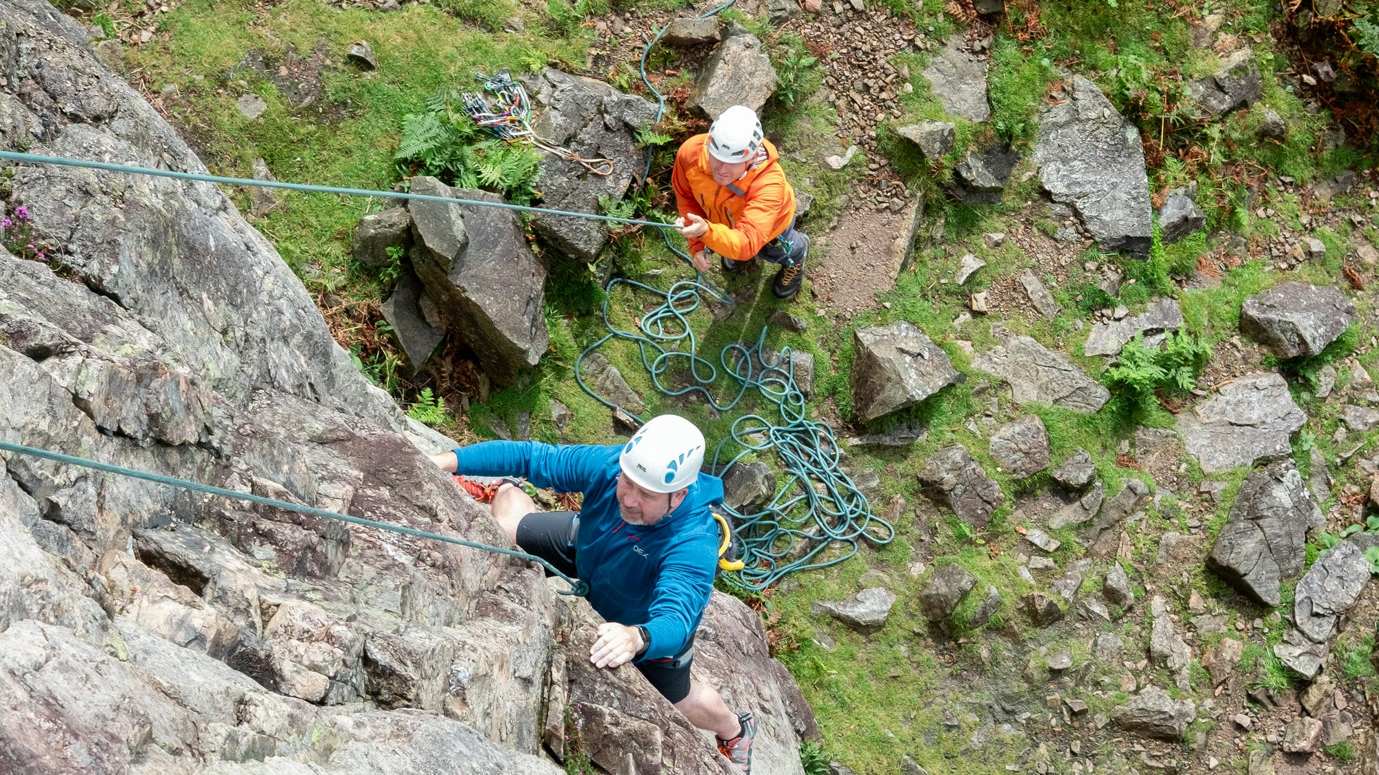 top down shot of someone climbing outdoors with an instructor