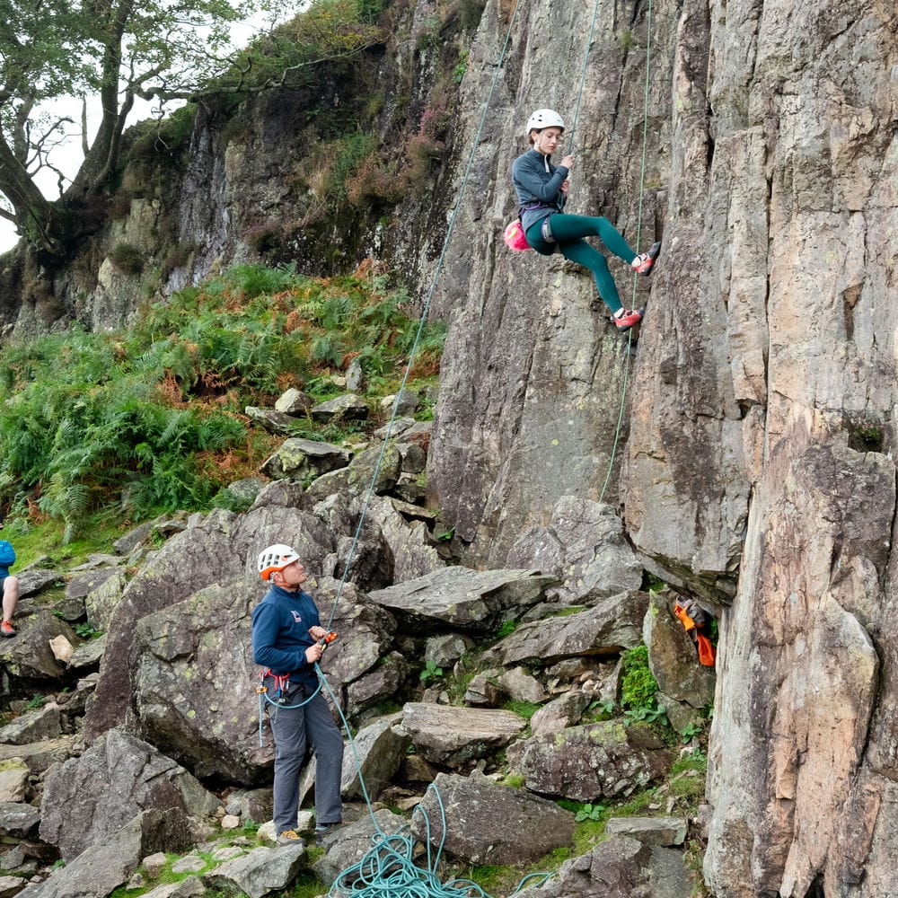 someone lowering off from the top off a climb